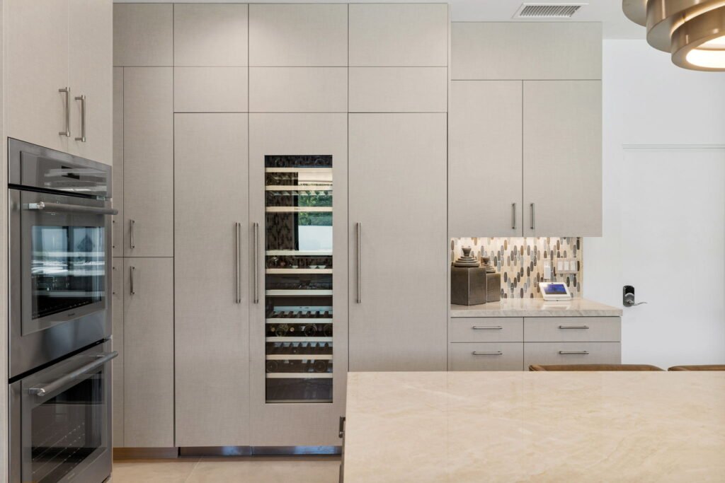 Custom cabinetry fit around custom wine cooler for modern kitchen near Riverside.