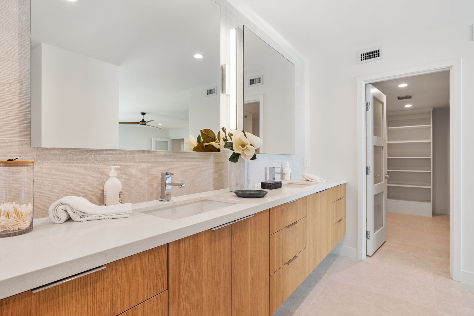 Premium custom cabinets by Laval bring this modern white bathroom to life.
