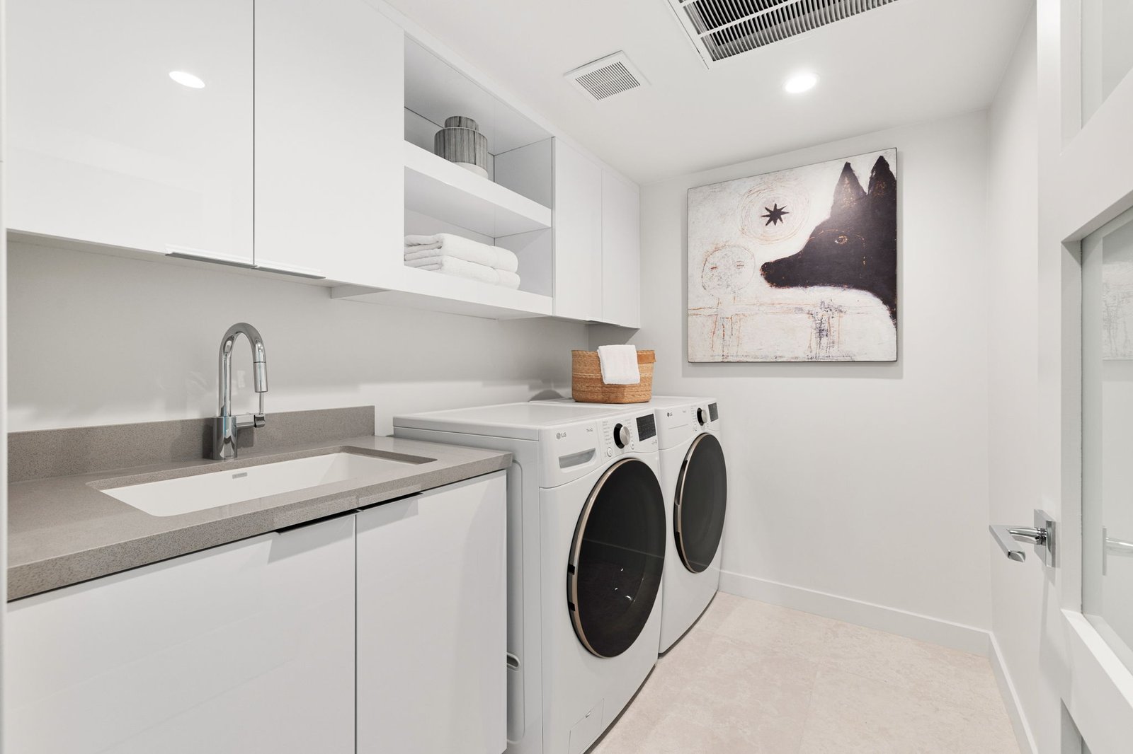Crisp white custom cabinets in this beautiful laundry room.