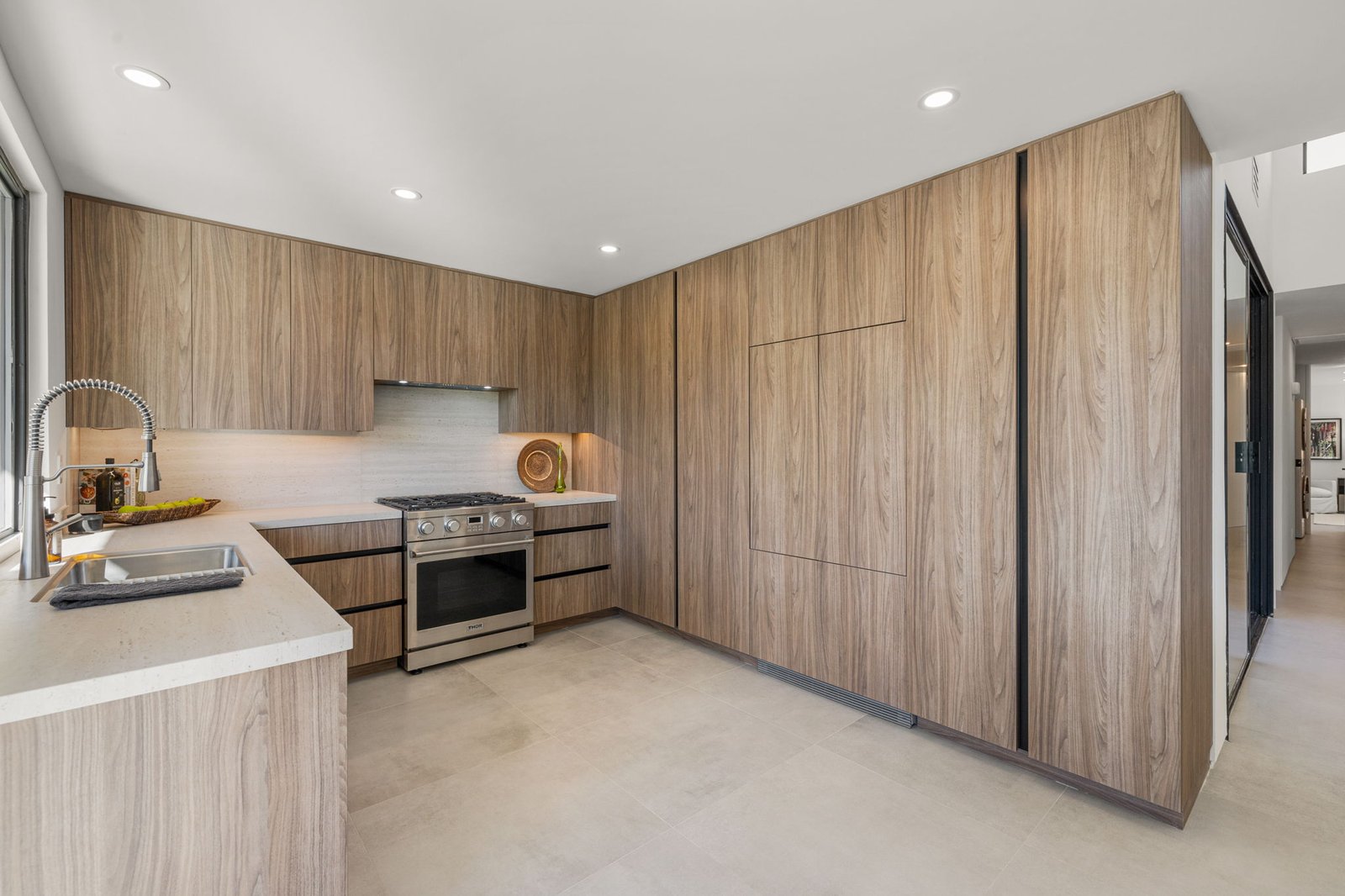 This kitchen is fitted with premium custom cabinetry from Laval, giving the room creative storage solutions and a modern look.